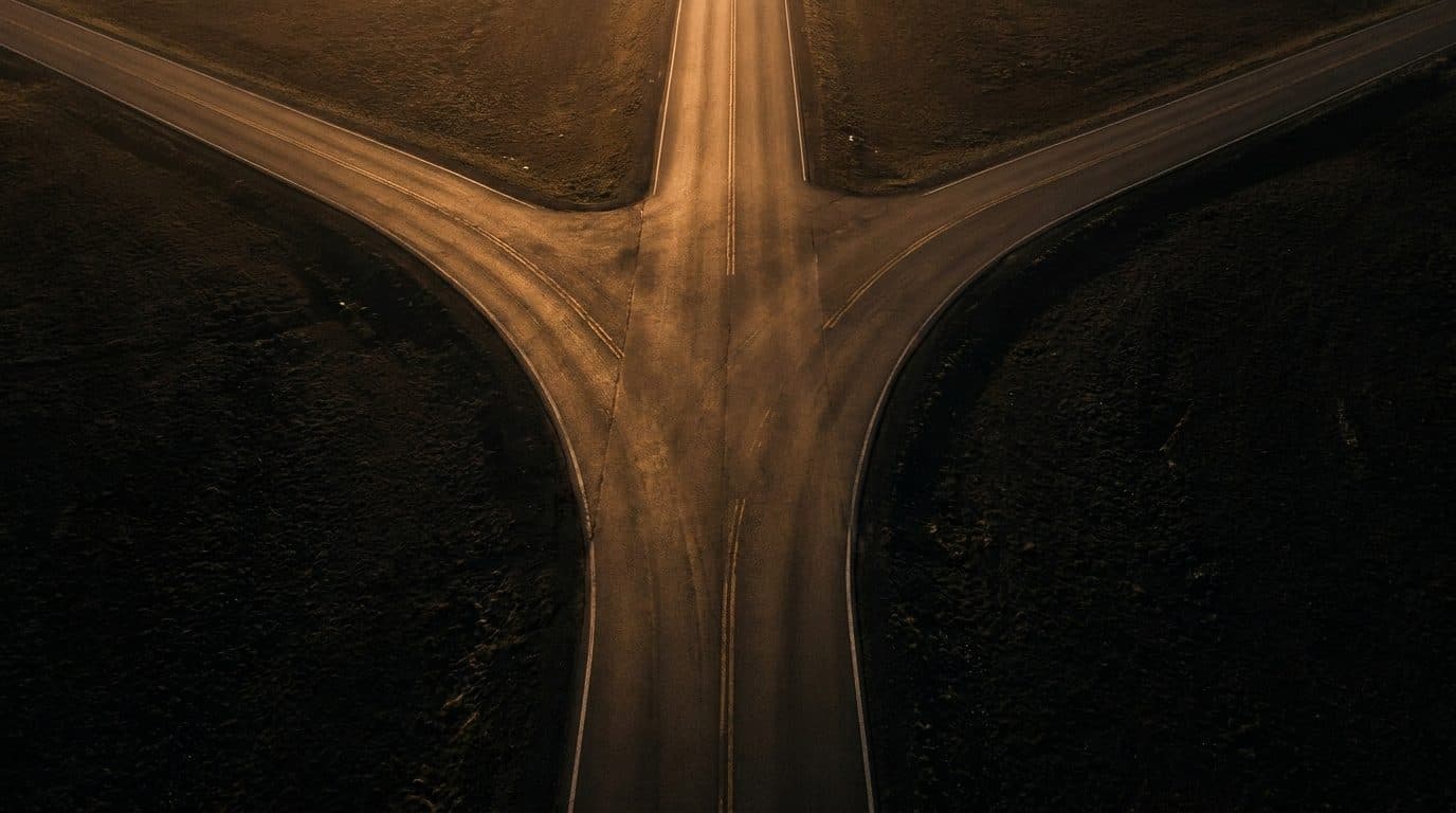 An aerial view of two roads merging into a single road at golden hour, a metaphor for two names for the same path.